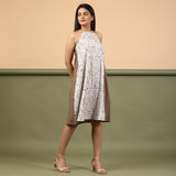 Right View of a Model wearing Taupe Tie-Dye Cotton Knee Length Halter Neck Dress