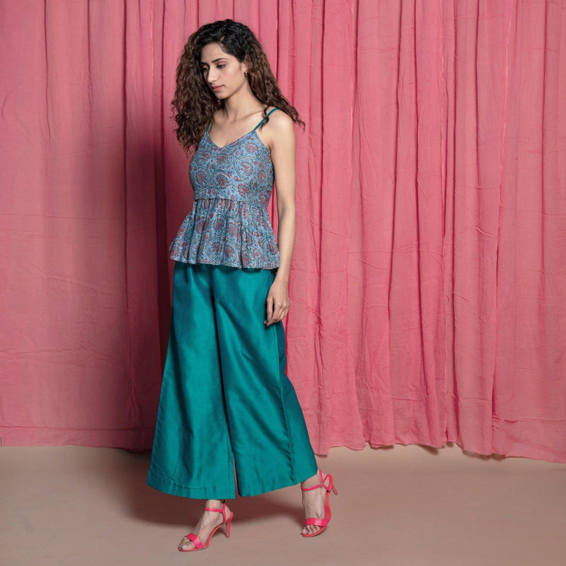 Left View of a Model wearing Teal Block Printed Chanderi Peplum Top