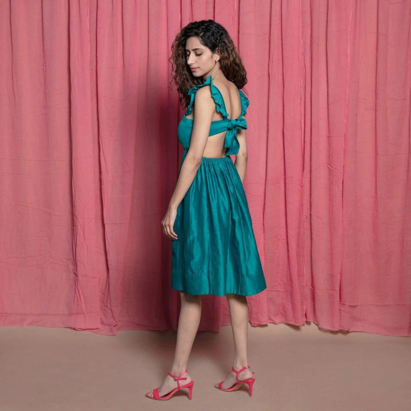 Left View of a Model wearing Teal Cotton Chanderi Knee Length Fit and Flare Dress