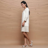 Left View of a Model wearing Undyed Ecru Handspun Cotton Muslin Knee Length A-Line Dress