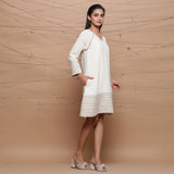 Right View of a Model wearing Undyed Ecru Handspun Cotton Muslin Knee Length A-Line Dress