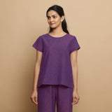 Front View of a Model wearing Violet Yarn Dyed Cotton Round Neck Godet Top