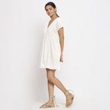 Left View of a Model wearing White Cotton Solid Wrap Dress