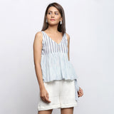 Right View of a Model wearing White And Blue Yarn Dyed Gathered Top