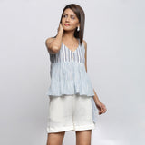 Front View of a Model wearing White and Blue Yarn Dyed Gathered Top