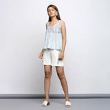 Front View of a Model wearing White and Blue Yarn Dyed Gathered Top