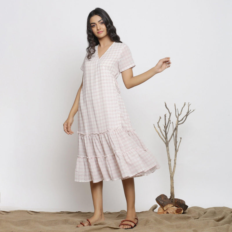 Left View of a Model wearing White And Pink Handspun Wrap Dress