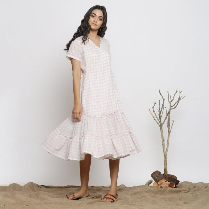 Right View of a Model wearing White And Pink Handspun Wrap Dress