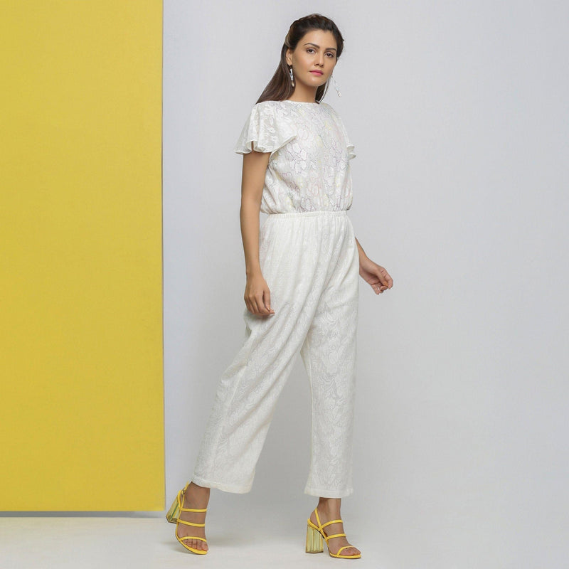 Right View of a Model wearing White Cotton Lace Hand Embroidered Jumpsuit