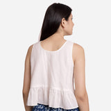 Back View of a Model wearing White Round Neck Cotton Peplum Top