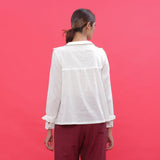 Back View of a Model wearing White Dobby Ruffled Peasant Blouse Top