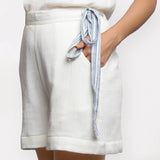 Left View of a Model wearing White Short Crinkled Cotton Shorts