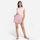 Front View of a Model wearing White Crinkled Cotton Frilled Elasticated Short Shorts