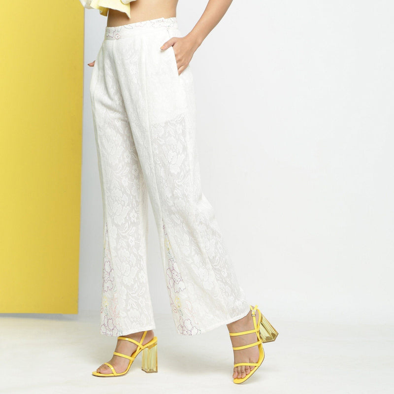 Left View of a Model wearing White Embroidered Cotton Lace Mid-Rise Paneled Pant