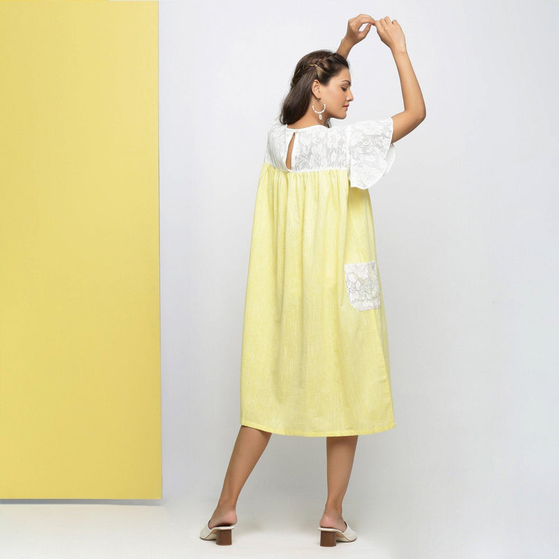 Back View of a Model wearing White Hand-Embroidered Gathered Dress