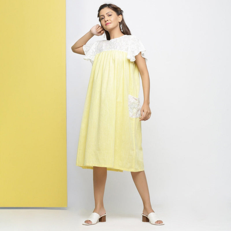 Front View of a Model wearing White Hand-Embroidered Cotton Lace Midi Yoked Dress