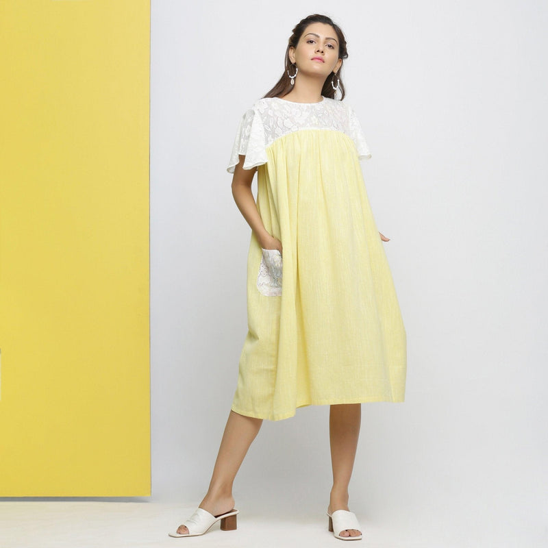 Front View of a Model wearing White Hand-Embroidered Cotton Lace Midi Yoked Dress