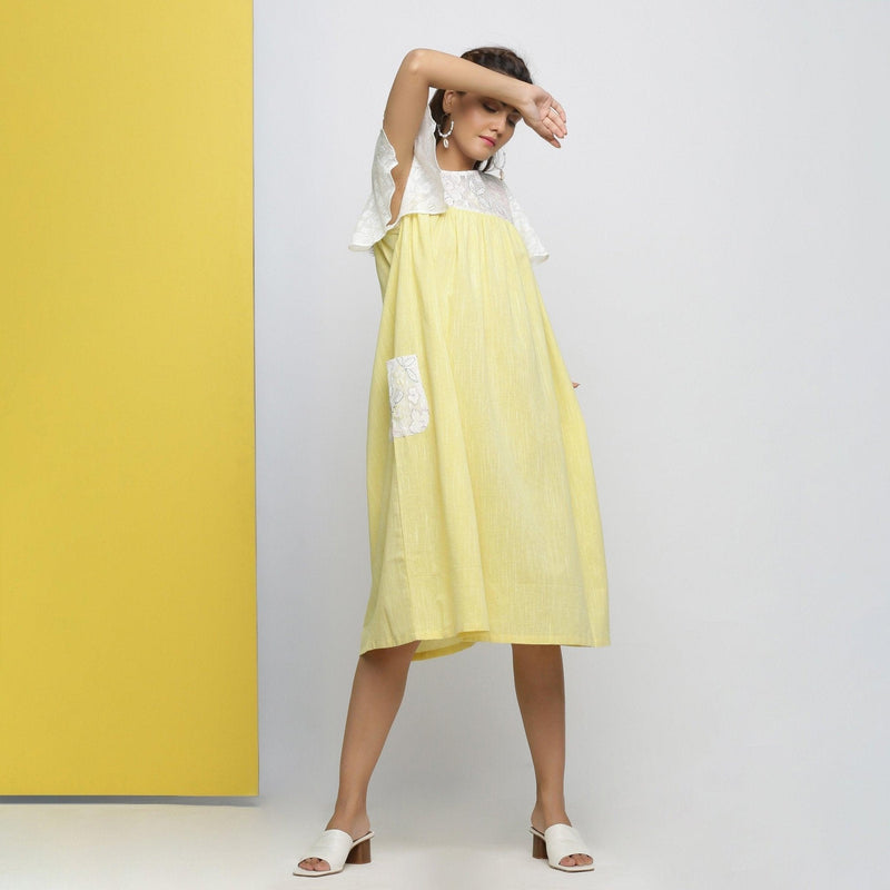 Right View of a Model wearing White Hand-Embroidered Gathered Dress