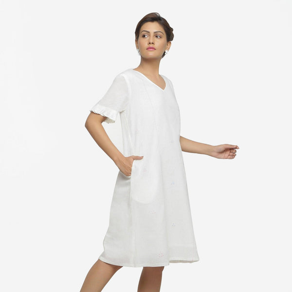 Right View of a Model wearing White Hand Embroidered Organic Cotton Knee Length Shift Dress