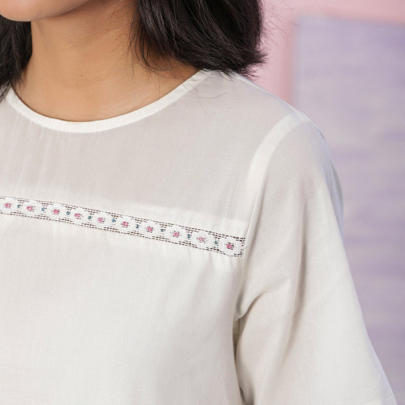 Front Detail of a Model wearing Organic Cotton White Beaded Lace A-Line Dress