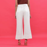 Back View of a Model wearing White Corduroy Hand Beaded Bootcut Pant