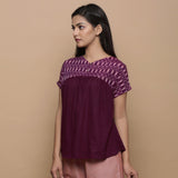 Front View of a Model wearing Wine Handspun Cotton Muslin V-Neck Gathered Yoke Top