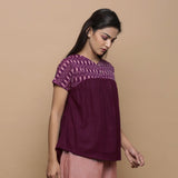 Right View of a Model wearing Wine Handspun Cotton Muslin V-Neck Gathered Yoke Top