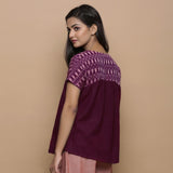 Left View of a Model wearing Wine Handspun Cotton Muslin V-Neck Gathered Yoke Top