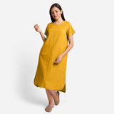 Front View of a Model wearing Yellow Cotton Welt Pocket Shift Dress