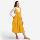 Right View of a Model wearing Yellow Deep Neck Pinafore Midi Wrap Dress