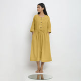 Front View of a Model wearing Vegetable-Dyed Yellow 100% Cotton Button-Down Dress