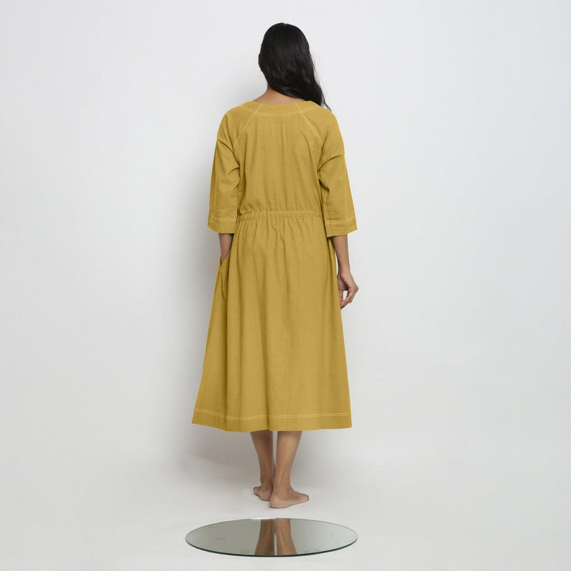 Back View of a Model wearing Vegetable-Dyed Yellow 100% Cotton Button-Down Dress