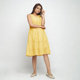 Front View of a Model wearing Yellow Hand Screen Printed Lined Tiered Dress