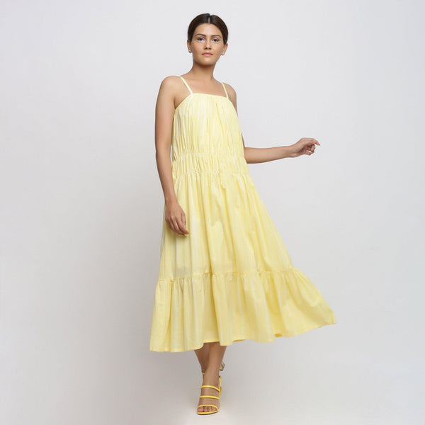 Front View of a Model wearing Yellow Tie and Dye Strap Tiered Dress