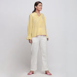 Right View of a Model wearing Yellow Hand Tie Dyed Shirred Blouson Top