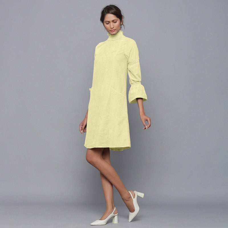 Left View of a Model wearing Yellow Pistachio Corduroy High Neck Dress