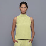 Front View of a Model wearing Yellow Pistachio Cotton Corduroy High Neck Top