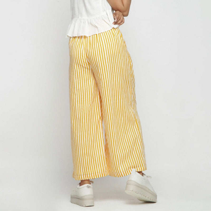 Back View of a Model wearing Yellow Striped Wide Legged Cotton Pant