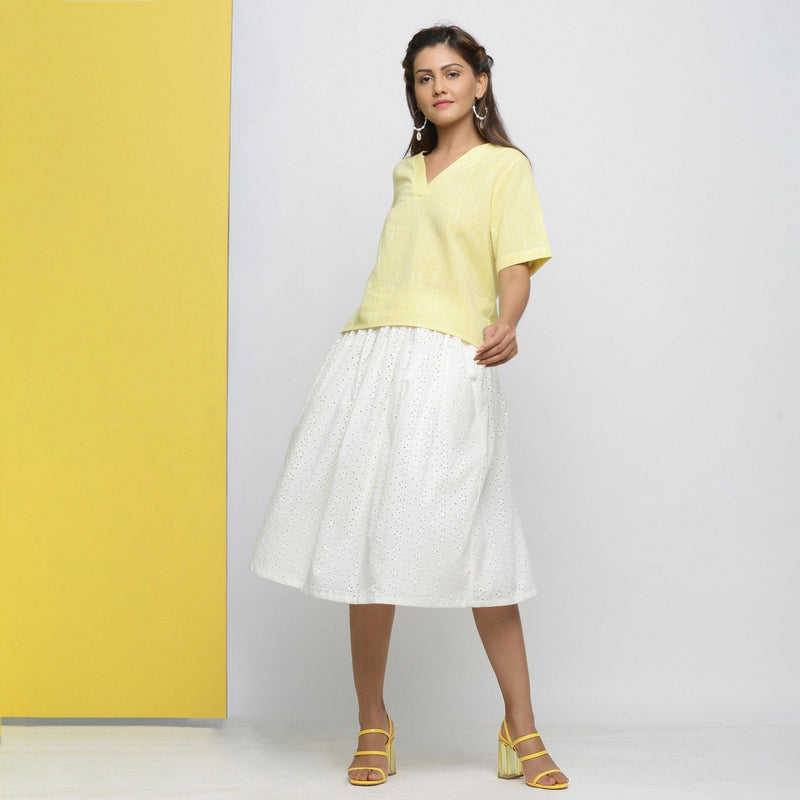 Front View of a Model wearing Yellow Yarn Dyed Cotton V-Neck High-Low Top