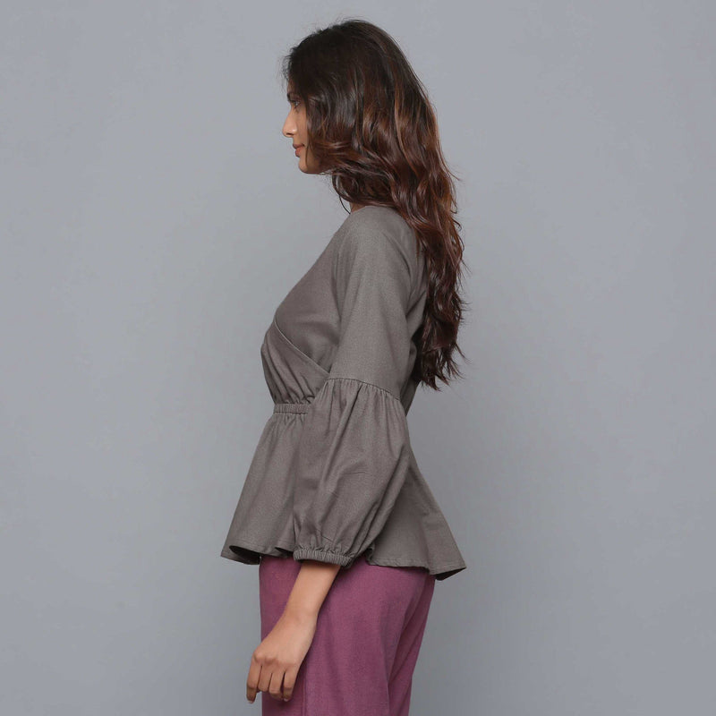 Left View of a Model wearing Ash Grey V-Neck Flannel Peplum Top