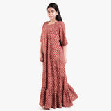 Left View of a Model wearing Brick Red Block Printed Cotton Floor Length Bohemian Dress