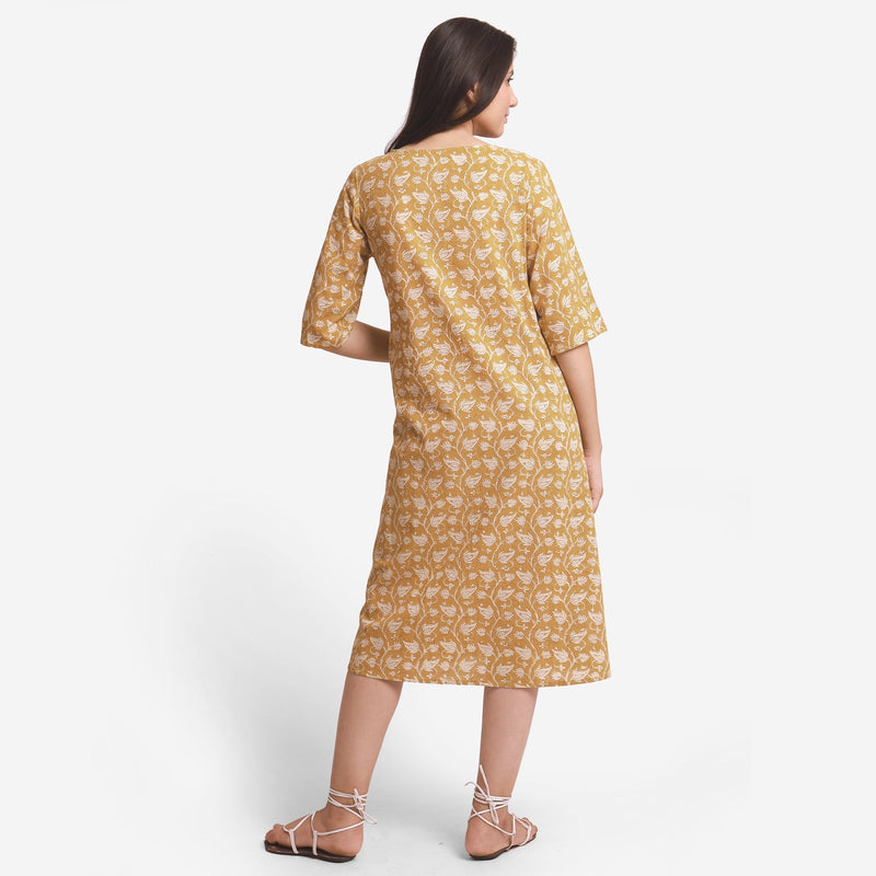 Back View of a Model wearing Mustard Block Printed Cotton Midi Yoke Dress