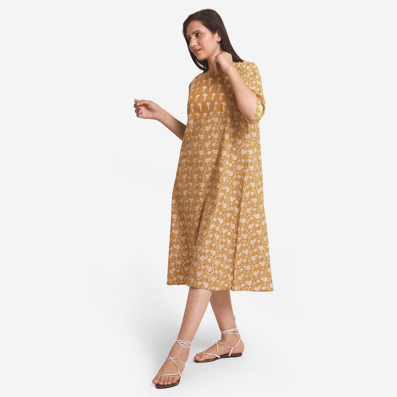 Left View of a Model wearing Mustard Block Printed Cotton Midi Yoke Dress