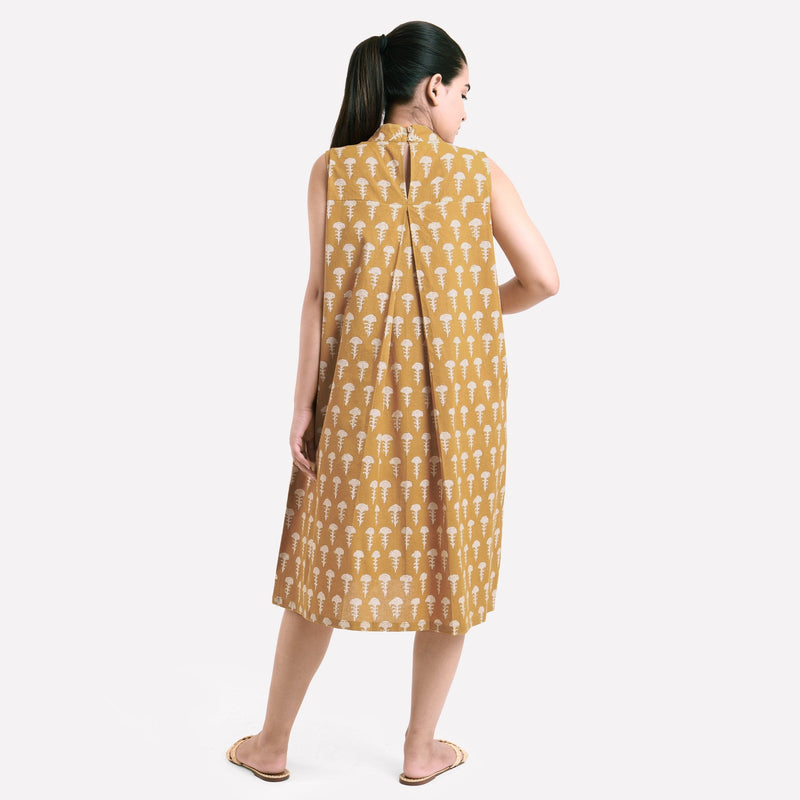 Back View of a Model wearing Mustard Bagru Block Print Pleated Cotton Midi Dress