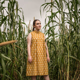 Right View of a Model wearing Mustard Bagru Block Print Pleated Cotton Midi Dress