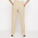 Back View of a Model wearing Beige Yarn Dyed Mid Rise Tapered Pant