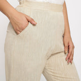 Front Detail of a Model wearing Beige Yarn Dyed Mid Rise Tapered Pant
