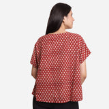 Back View of a Model wearing Brick Red Block Print Flared Round Neck Cotton Top