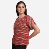 Left View of a Model wearing Brick Red Block Print Flared Round Neck Cotton Top