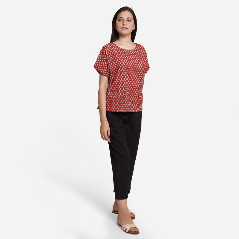 Right View of a Model wearing Brick Red Block Print Flared Round Neck Cotton Top